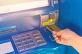 Hand insert credit card to ATM bank cash machine for withdraw mo Royalty Free Stock Photo