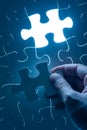 Hand insert jigsaw, conceptual image of business strategy