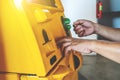 Hand inserting ATM card into bank machine and hand entering PIN/pass code on ATM/bank machine keypad to withdraw money Royalty Free Stock Photo