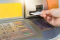 Hand inserting ATM card into bank machine. Royalty Free Stock Photo