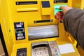 Hand inserting ATM card into bank machine to withdraw money Royalty Free Stock Photo