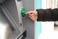 Hand inserting ATM card into bank machine to withdraw money Royalty Free Stock Photo