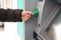 Hand inserting ATM card into bank machine to withdraw money Royalty Free Stock Photo