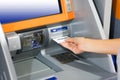 Hand inserting ATM card into bank machine for withdraw money Royalty Free Stock Photo