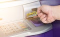 Hand inserting ATM credit card into bank machine Royalty Free Stock Photo