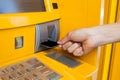 Hand inserting card into cash machine