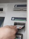 Hand inserting a card into a cashpoint machine Royalty Free Stock Photo