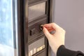 hand inserting a coin in a vending machine Royalty Free Stock Photo