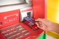 Hand inserting with a credit card into bank machine . Man using Royalty Free Stock Photo