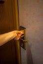 Hand inserting a key card into a hotel room electronic door security lock to unlock the door Royalty Free Stock Photo