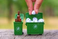 Hand Inserting Paper Waste Into Green Minibin For Recycling Royalty Free Stock Photo