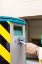 Hand is inserting parking ticket into barrier of g Royalty Free Stock Photo