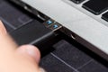 Hand inserting USB flash memory drive plugged into a computer laptop port. Royalty Free Stock Photo