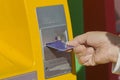 Hand inserts ATM card.