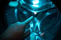 A Hand inside washer pointing a finger Royalty Free Stock Photo