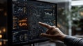 Hand interacting with advanced data analysis dashboard on computer screen displaying graphs and charts in modern workspace