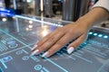 Hand interacting with a futuristic touchscreen interface in a modern setting Royalty Free Stock Photo