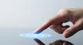 A hand interacting with a glowing blue interface on a touchscreen device Royalty Free Stock Photo