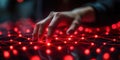 Hand interacting with glowing red network of lights in a dark environment, creating a sense of digital connection Royalty Free Stock Photo