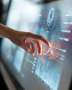 Hand interacting with large touchscreen displaying data charts and futuristic interfaces Royalty Free Stock Photo