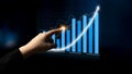 Hand touching digital interactive screen with upward graph, financial trends, and data analysis concept in modern Royalty Free Stock Photo