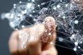 A hand interacts with a digital world map composed of interconnected white lines