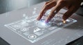 A hand interacts with a futuristic, digital interface projected on a flat surface. The Royalty Free Stock Photo