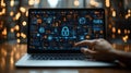 A hand interacts with a laptop displaying digital security graphics and data analysis Royalty Free Stock Photo