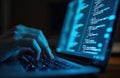 Hand interacts with laptop screen, displays computer code. Programmer focused on task in dimly lit room. Screen glow illuminates Royalty Free Stock Photo