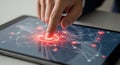 Close up of a finger touching a glowing red digital network interface on a tablet screen Royalty Free Stock Photo