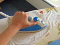 Hand ironing white t-shirt Royalty Free Stock Photo