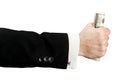 A hand in a jacket and shirt clutches dollars Royalty Free Stock Photo