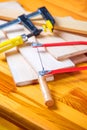 Hand jigsaw, wood and clamps are on the table