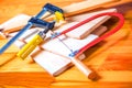 Hand jigsaw, wood and clamps are on the table