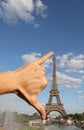 hand that jokingly measures the Eiffel Tower with the span Royalty Free Stock Photo