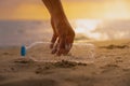 Hand Keep cleanup the Plastic bottle on beach at the sunset sc Royalty Free Stock Photo