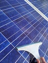 Hand cleaning solar panels Royalty Free Stock Photo