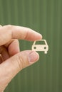 The hand keeps the car on a blurry green background. Car insurance. Man is holding car. my car. vertical photo