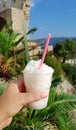 Hand keeps granita to take away in a plastic cup