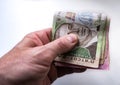 Hand holds Ukrainian money hryvnia