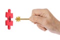 Hand with key and puzzle Royalty Free Stock Photo