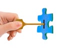 Hand with key and puzzle Royalty Free Stock Photo