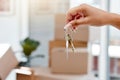 Hand, keys and new home with moving boxes or real estate investment or approval, mortgage or property. Person, fingers Royalty Free Stock Photo