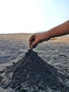 Hand of kid child play sand make a mount of sand near the beach Royalty Free Stock Photo