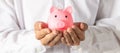 Hand of kid holding coin put in piggy bank with money stack growing growth saving money, Concept invesment for financial freedom Royalty Free Stock Photo