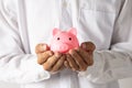 Hand of kid holding coin put in piggy bank with money stack growing growth saving money, Concept invesment for financial freedom Royalty Free Stock Photo