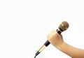 Hand kid holding microphone on white background. Royalty Free Stock Photo