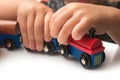 hand of kid playing with wooden train on white background Royalty Free Stock Photo