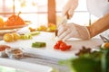 Hand with knife cuts egg. Royalty Free Stock Photo