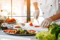 Hand with knife cuts pepper. Royalty Free Stock Photo